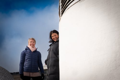 data management experts Nandita and Eva looking at camera